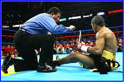 Referee Bobby Ferraro delivers the count to Shamba Mitchell after Mitchell was knocked down for the second time.