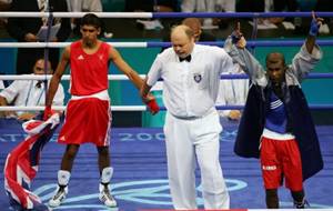 Amir Khan (L) of Great Britain looks on as Mario Cesar Kindelan Mesa of Cuba (Blue) is announced the winner after the men's boxing 60 kg final bout  at Peristeri Olympic Boxing Hall in Athens on 29/08/2004  GETTY IMAGES/Scott Barbour 