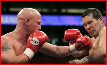 Julio Cesar Chavez Sr., right, reacts after getting hit by Grover Wiley in the fifth round of the the welterweight division fight at America West A