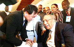 NO HARD FEELINGS: Kuo (left) shakes hands with Chowdhry