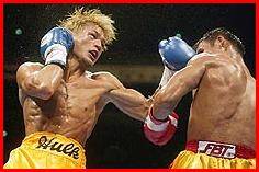 Japanese challenger Osamu Sato launches a left upper hook